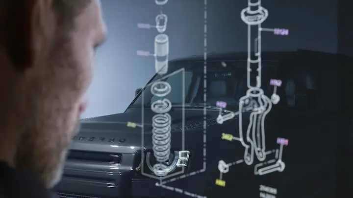 A man looking at a diagram of range rover parts